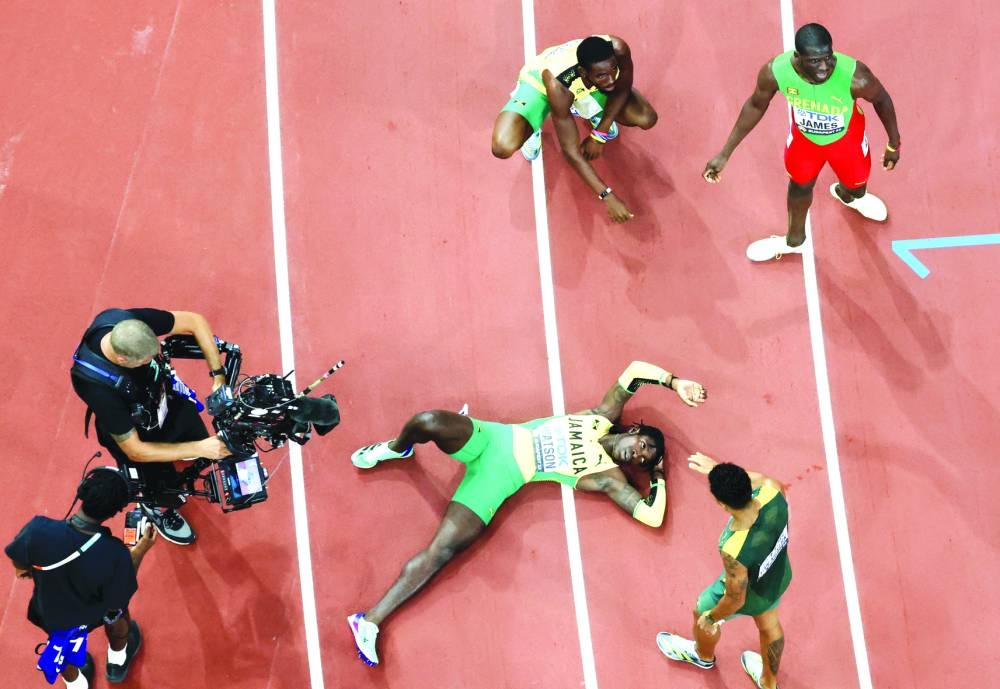 
Jamaica’s Antonio Watson lies on the ground after winning the 400m gold. (Reuters) 