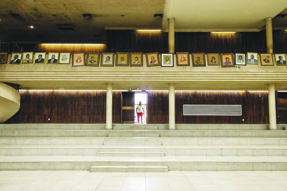 
A man walks into the Zimbabwe African National Union – Patriotic Front’s (ZANU-PF) conference hall where portraits of former ZANU-PF leaders and freedom fighters are displayed in Harare. 