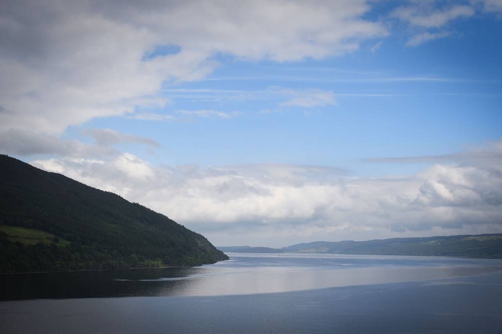  Clouds are seen against a blue sky above Loch Ness in the Scottish Highlands on June 10, 2018.  AFP