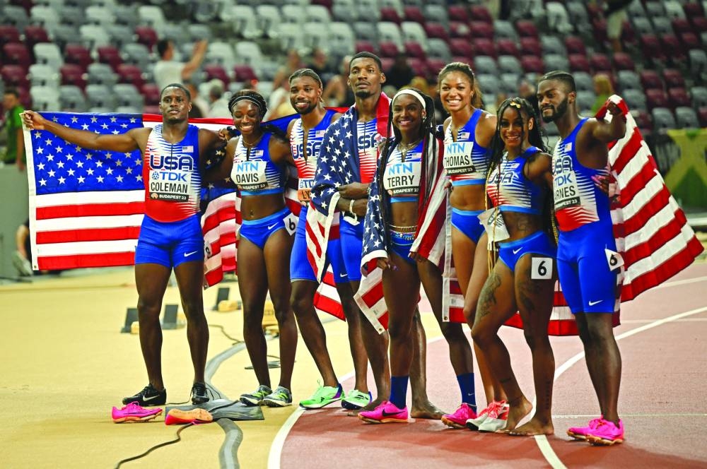 
US men and women’s 4x100m gold medallists Tamari Davis, Twanisha Terry, Gabrielle Thomas, Sha’carri Richardson, Christian Coleman, Fred Kerley, Brandon Carnes and Noah Lyles celebrate after their victories in Budapest. (Reuters) 