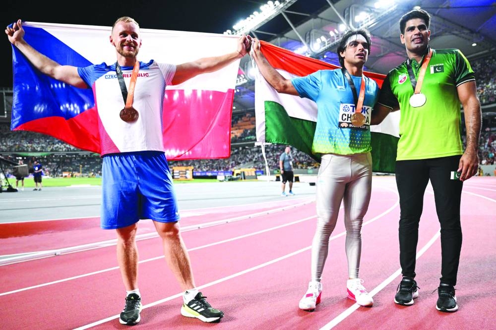 Bronze medallist from Czech Republic Jakub Vadlejch (left), gold medallist from India Neeraj Chopra (centre) and silver medallist from Pakistan Arshad Nadeem celebrate with their medals after the javelin throw final during the World Athletics Championships at the National Athletics Centre in Budapest on Sunday. (AFP)