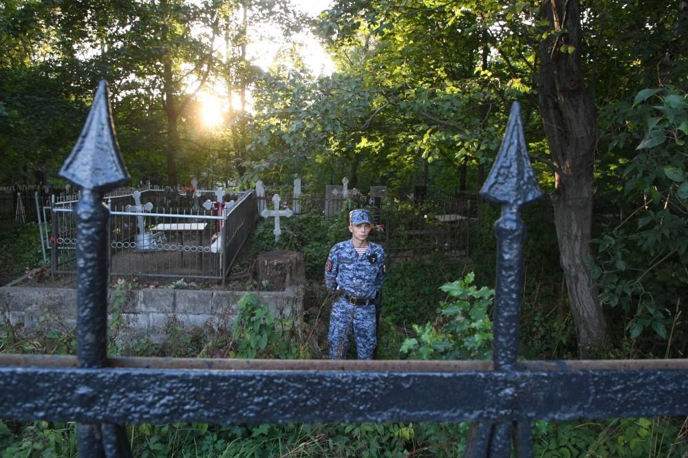 A Russian National Guard (Rosgvardiya) serviceman stands guard at the Porokhovskoye cemetery where Wagner private mercenary group chief Yevgeny Prigozhin, who was killed in a private jet crash in the Tver region last week, was buried, in Saint Petersburg. AFP