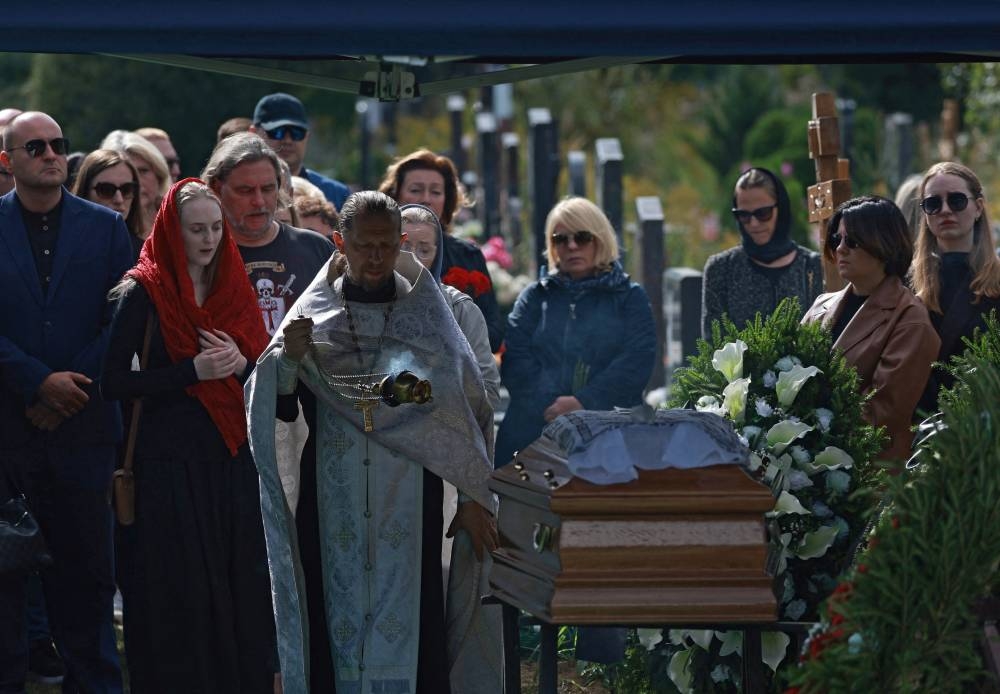 An Orthodox priest conducts a service during the funeral for Valery Chekalov, logistics chief of the Wagner private mercenary group, at the Severnoye cemetery in Saint Petersburg, Russia August 29, 2023. REUTERS/Stringer