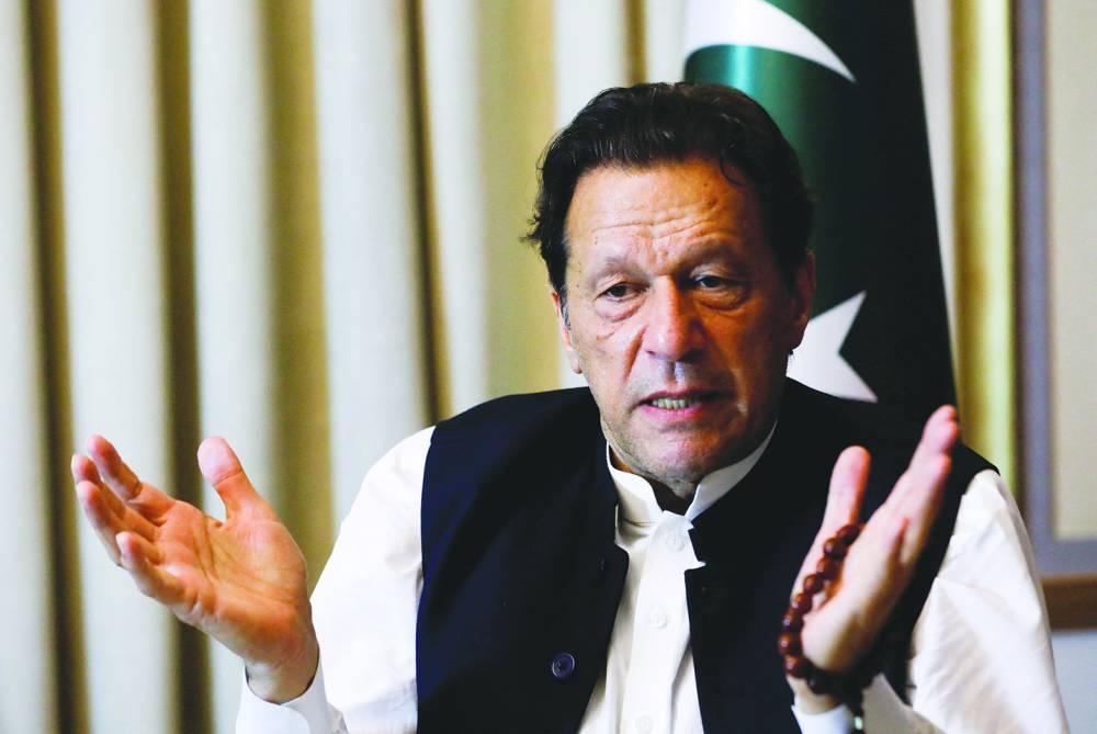 
Former Pakistani prime minister Imran Khan gestures as he speaks with Reuters during an interview in Lahore last March. Below: Gohar Khan, leading lawyer of the legal team of imprisoned Khan, speaks with the media outside the Islamabad High Court in Islamabad yesterday. (AFP) 