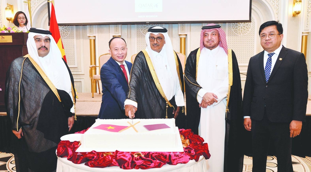 Vietnam ambassador Tran Duc Hung is joined by Qatar's Minister of Justice HE Masoud bin Mohamed al-Ameri in cutting a ceremonial cake yesterday at the function as Qatar's Ministry of Foreign Affairs' Department of Protocol director Ibrahim Fakhro and other dignitaries look on. PICTURES: Shaji Kayamkulam.