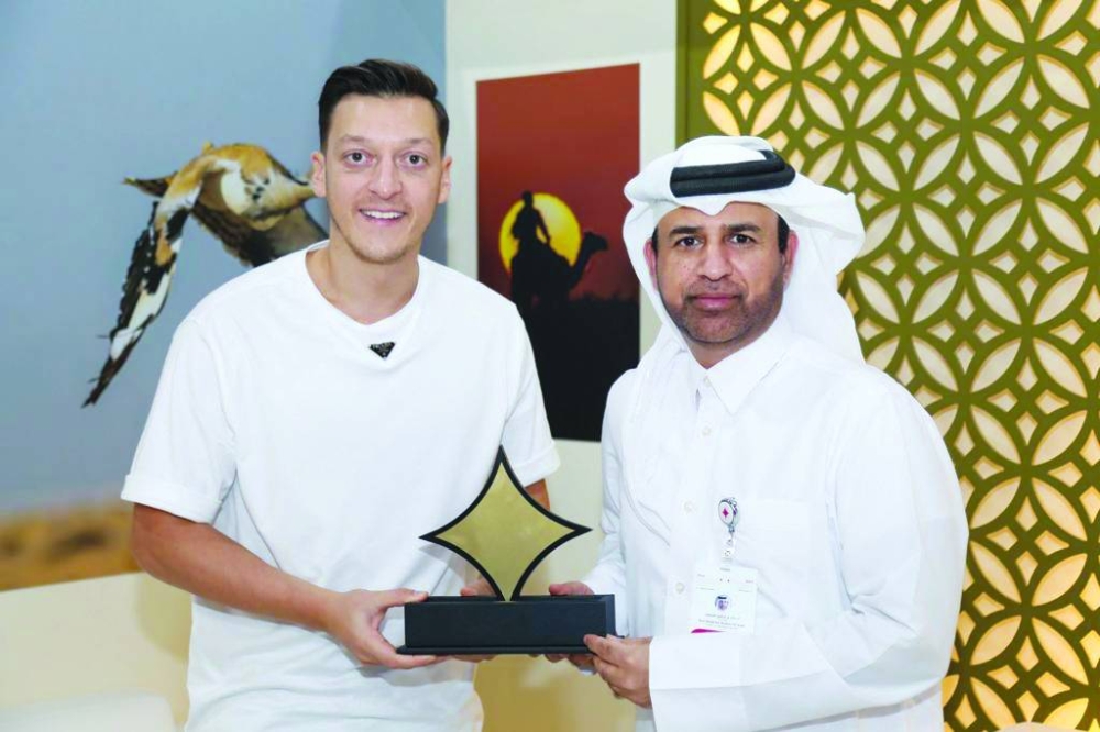 Mesut Ozil with Dr al-Sulaiti,