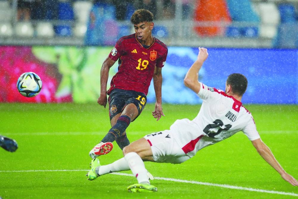 Spain’s Lamine Yamal (left) scores against Georgia during the Euro 2024 qualifying match in Tbilisi, Georgia, on Friday. (Reuters)