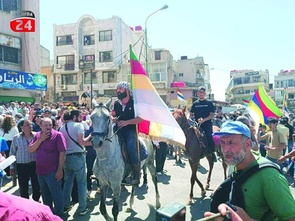 
People take part in a protest against Syria’s President Bashar al-Assad in the southern city of Sweida, Syria, yesterday. 