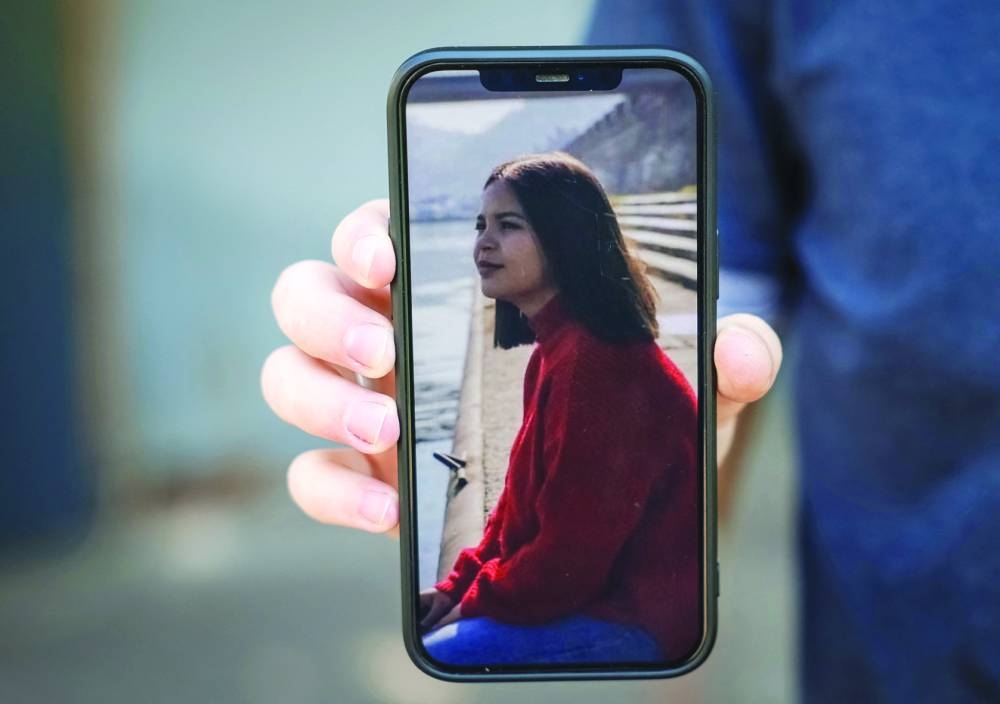 
Aziz Umerov in Kyiv shows a portrait of his sister Leniye Umerova, a Ukrainian from Russian-annexed Crimea, arrested in Russia. (Reuters) 