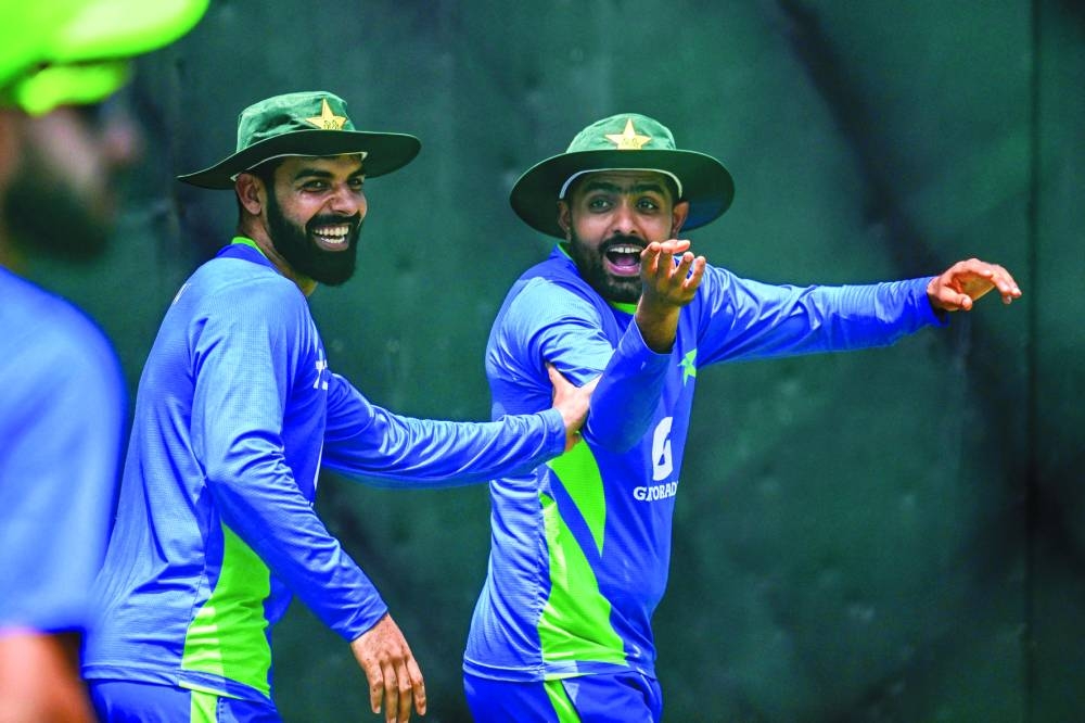 Pakistan’s captain Babar Azam (right) and Shadab Khan gesture during a practice session at the R. Premadasa Stadium in Colombo on Saturday, on the eve of their Asia Cup Super Four match against India. (AFP)