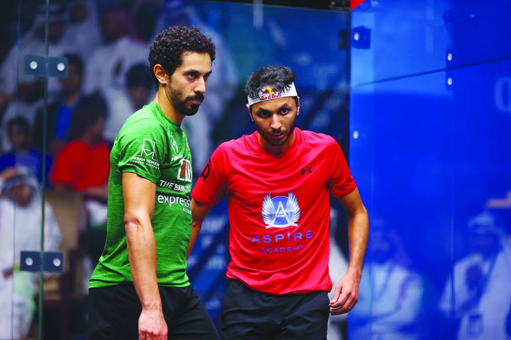 Qatar's Mohamed Abdullah al-Tamimi (right) congratulates eighth seed Tarek Momen of Egyot after their third-round clash at Khalifa International Tennis and Squash Complex in Doha on Tuesday.