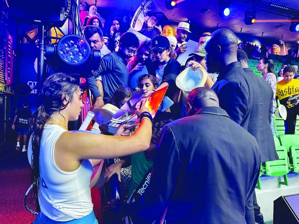 Nour El Sherbini of Egypt signs autographs after beating Belgium’s Nele Gilis on Wednesday.