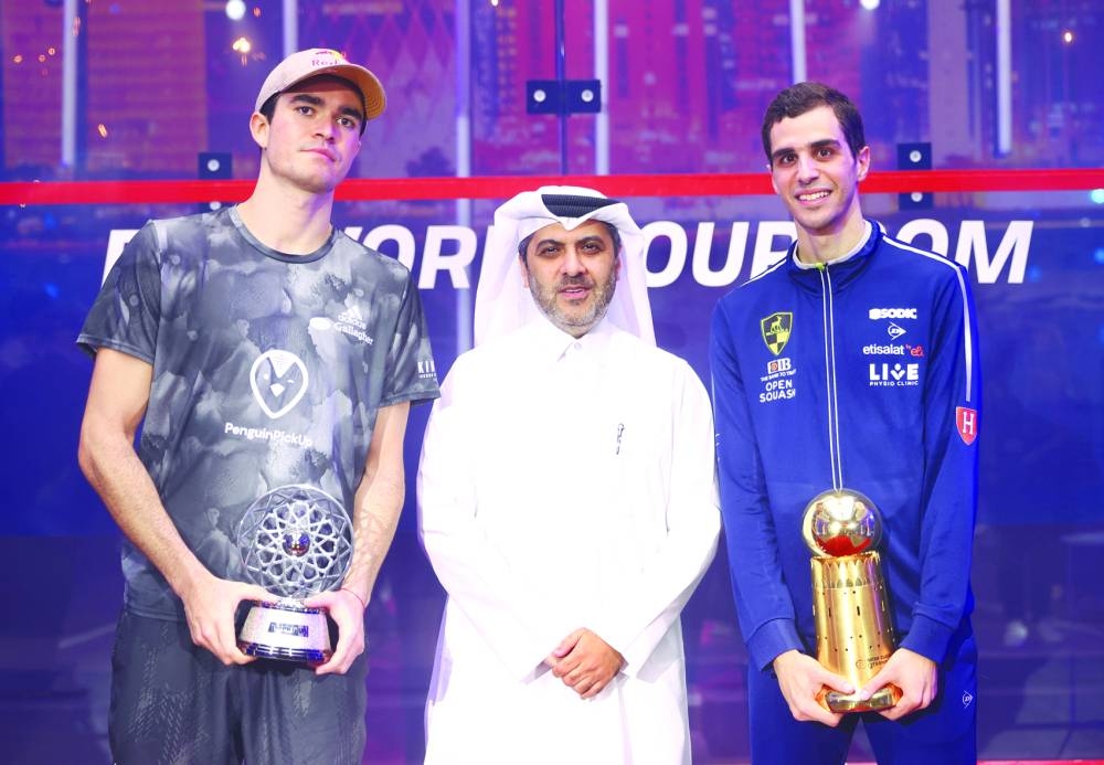 QTerminals Qatar Classic champion Ali Farag (right) and runner-up Diego Elias (left) pose with Tareq Zainal, secretary-general of the Qatar Tennis, Squash and Badminton Federation, after the final at the Khalifa International Tennis & Squash Complex on Saturday.