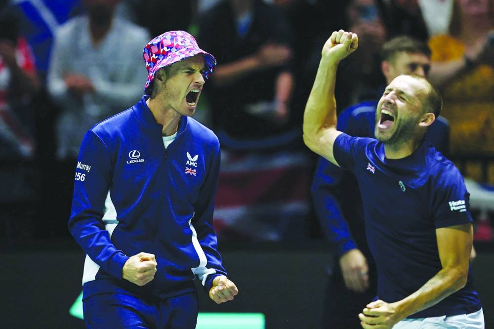 Britain’s Andy Murray (left) celebrates with Daniel Evans after the latter and teammate Neal Skupski beat France’s Edouard Roger-Vasselin and Nicolas Mahut in their doubles Davis Cup match at the AO Arena in Manchester, northern England, on Sunday. (Reuters)