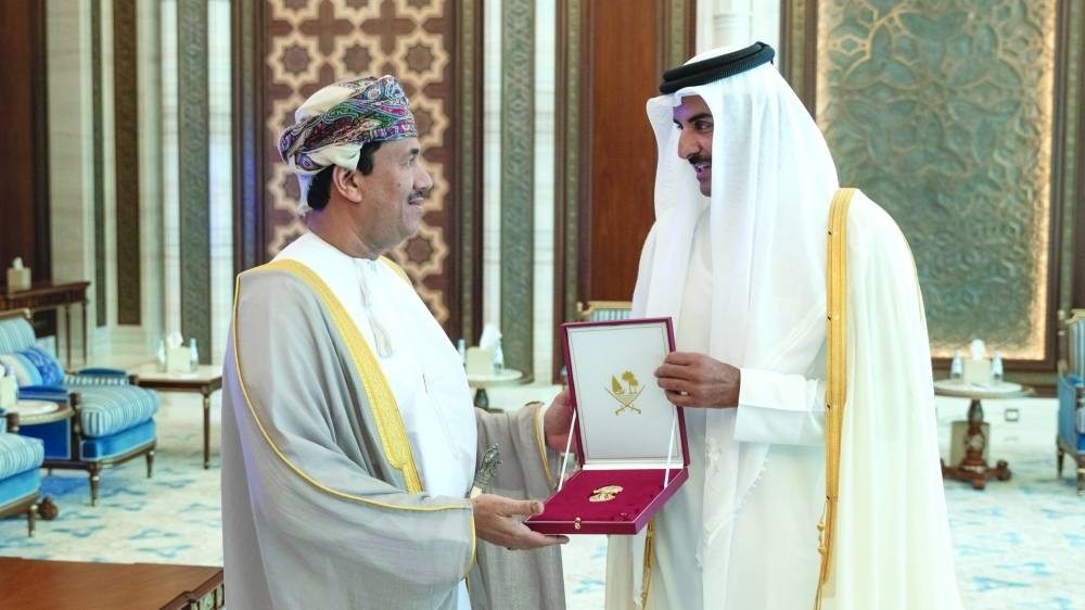 His Highness the Amir Sheikh Tamim bin Hamad al-Thani grants the the Al Wajbah Decoration to the Ambassador of the Sultanate of Oman to Qatar Najib bin Yahya al-Balushi.