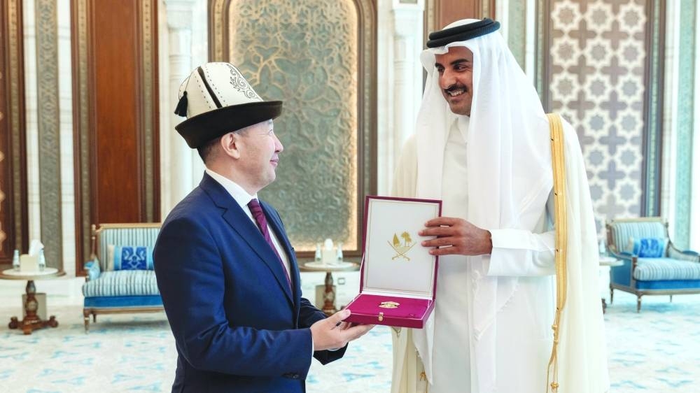 His Highness the Amir Sheikh Tamim bin Hamad al-Thani grants the the Al Wajbah Decoration to the Ambassador of Kyrgyz Republic to Qatar Chyngyz Eshimbekov.