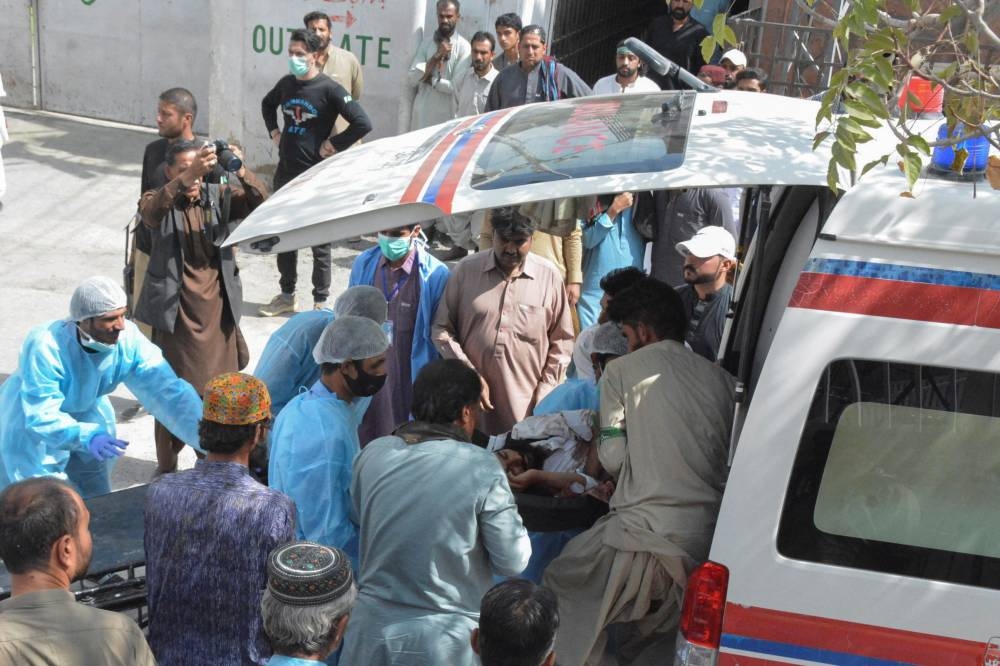 Men and paramedic staff transfer a man, who was injured in a blast in Mastung, from an ambulance outside hospital in Quetta, Pakistan. REUTERS