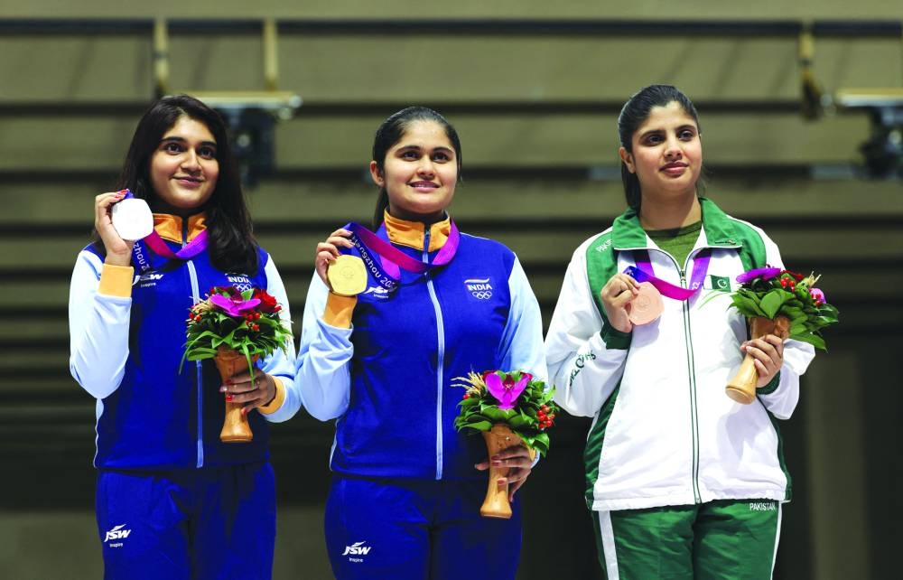 
Gold medallist Palak Gulia (centre) of India, silver medallist Esha Singh (left) of India and bronze medallist Kishmala Talat of Pakistan pose after the 10m air pistol final. (Reuters) 