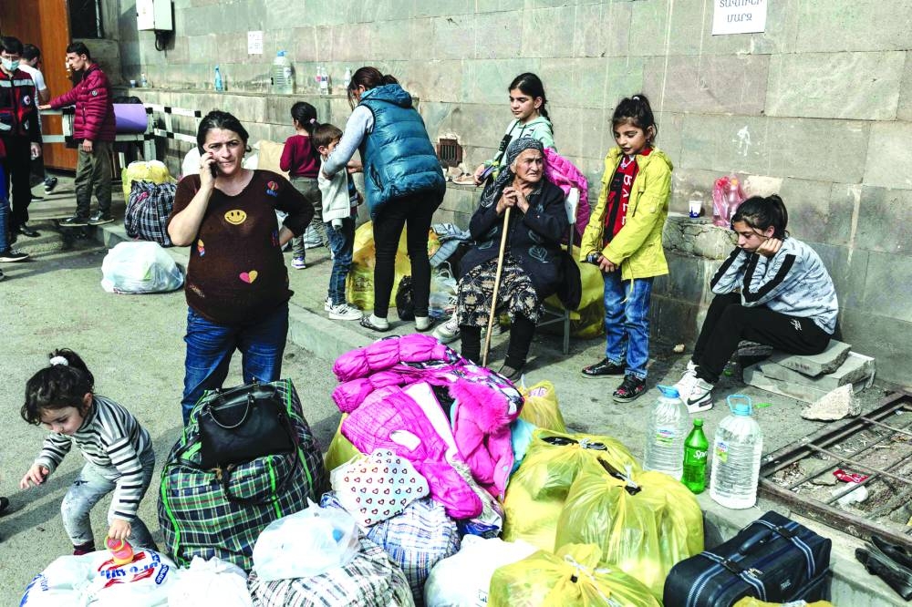 Armenian refugees from Nagorno-Karabakh are seen in the center of the town of Goris yesterday before being evacuated to various Armenian cities. 