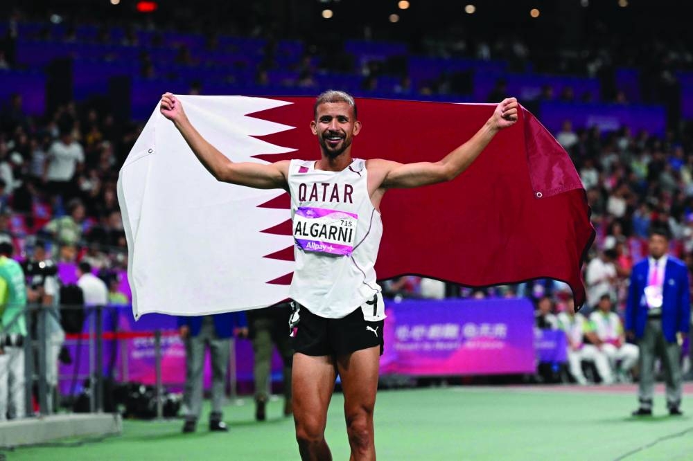 Qatar’s Mohamed al-Garni celebrates winning the 1,500m race during the 2022 Asian Games in Hangzhou on Sunday. (AFP)
