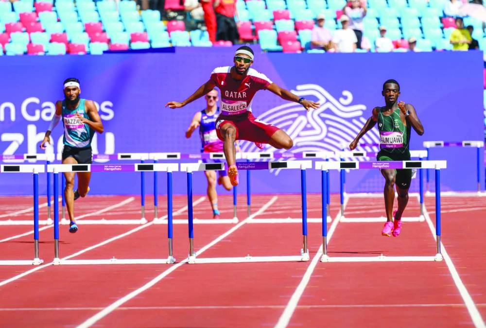 Qatar’s Abderrahaman Samba (centre) competes during the 400m hurdles heats at the Olympic Sports Centre Stadium in Hangzhou, China, yesterday.