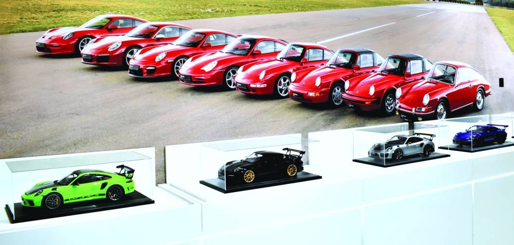 Four of the model Porsche cars (foreground) at the exhibition.
