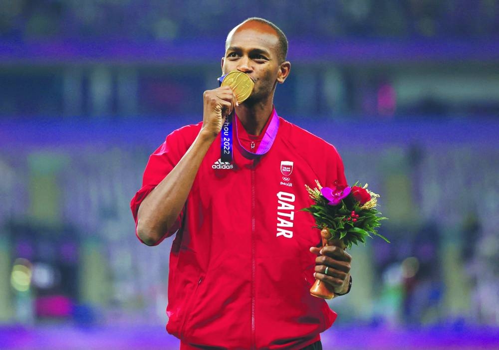 Gold medallist Qatar’s Mutaz Barshim kisses his medal during the podium ceremony for the high jump. (Reuters)