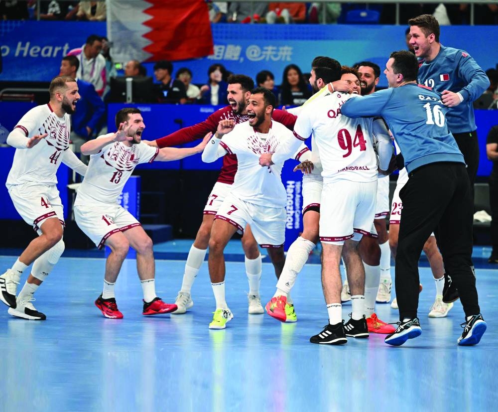 
Qatar’s handball players celebrate after victory over Bahrain in the final at the Asian Games in Hangzhou, China. (AFP) 