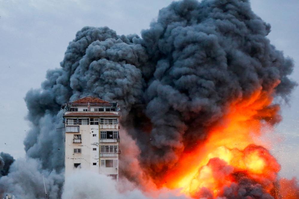 Smoke and flames billow after Israeli forces struck a high-rise tower in Gaza City Saturday. Reuters