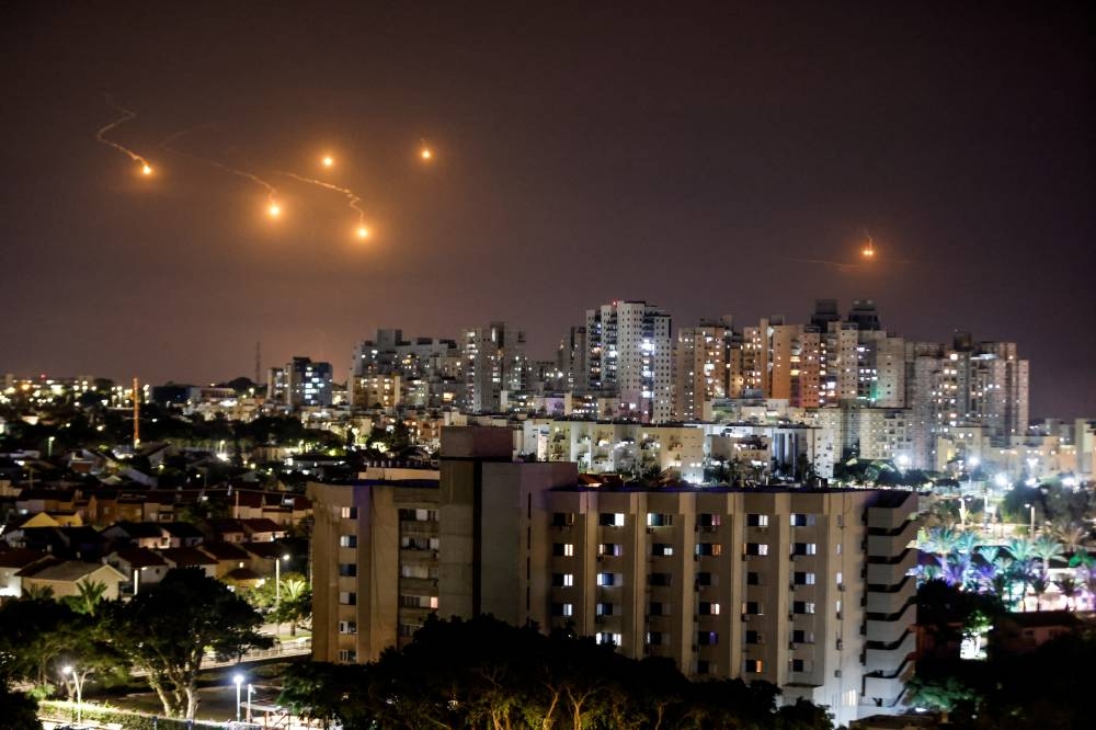 Flares illuminate the sky over northern Gaza, as seen from Ashkelon, southern Israel Saturday. REUTERS