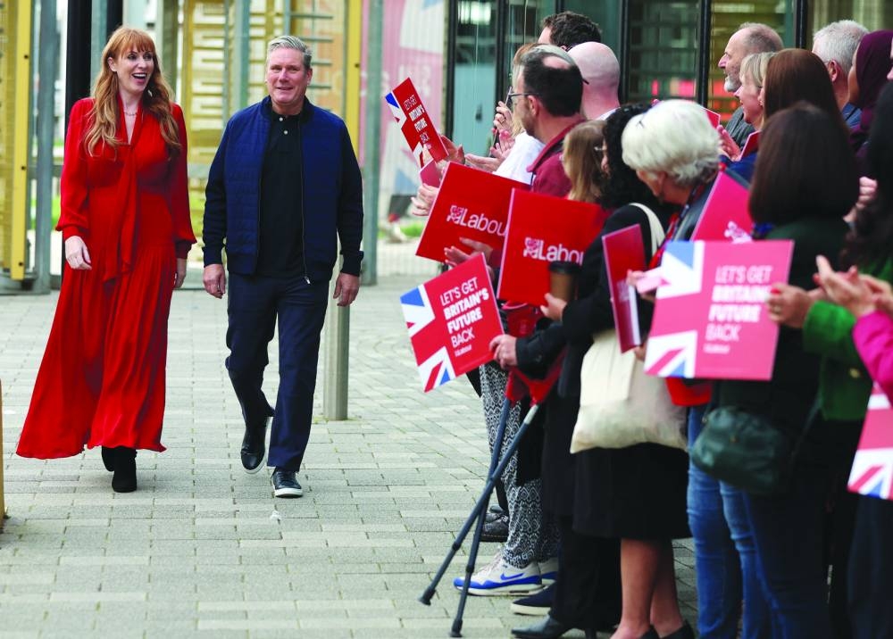 
Britain’s Labour Party Leader Keir Starmer arrives with his deputy Angela Rayner ahead of the start of, Britain’s Labour Party annual conference in Liverpool, Britain. 