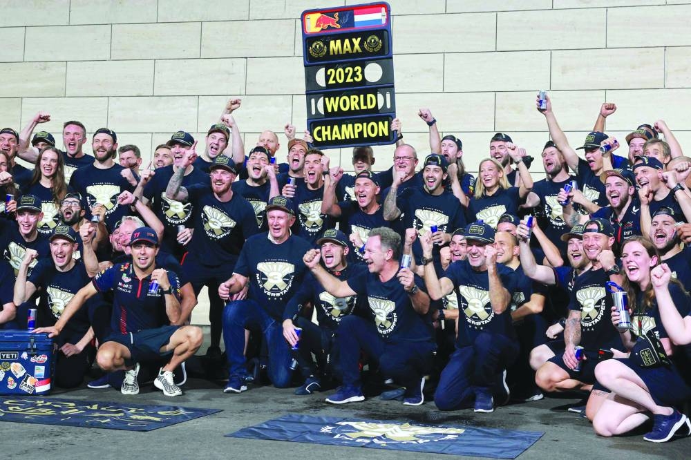 Red Bull Racing’s Dutch driver Max Verstappen (centre) celebrates his third world championship title with his crew at the Lusail International Circuit on Saturday. (AFP)