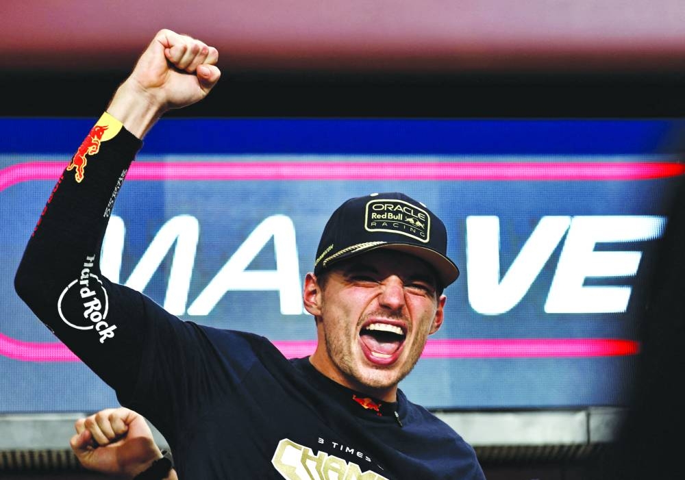 Red Bull's Max Verstappen celebrates after winning the championship.