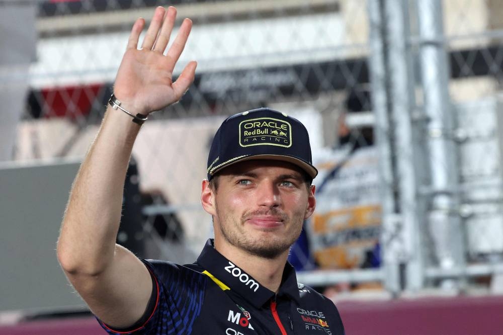 Red Bull Racing's Dutch driver Max Verstappen greets the fans ahead of the Qatari Formula One Grand Prix at Lusail International Circuit. Giuseppe CACACE / AFP