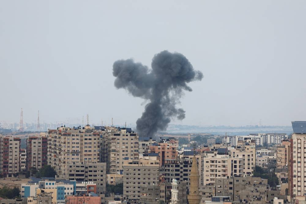 Smoke rises following Israeli strikes in Gaza, Sunday. REUTERS/Mohammed Salem