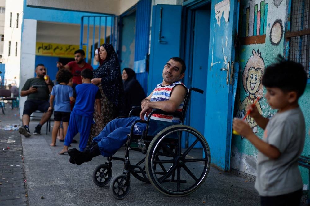 Palestinians who fled their homes amid Israeli strikes, shelter in a United Nations-run school, in Gaza City Sunday. REUTERS/Mohammed Salem