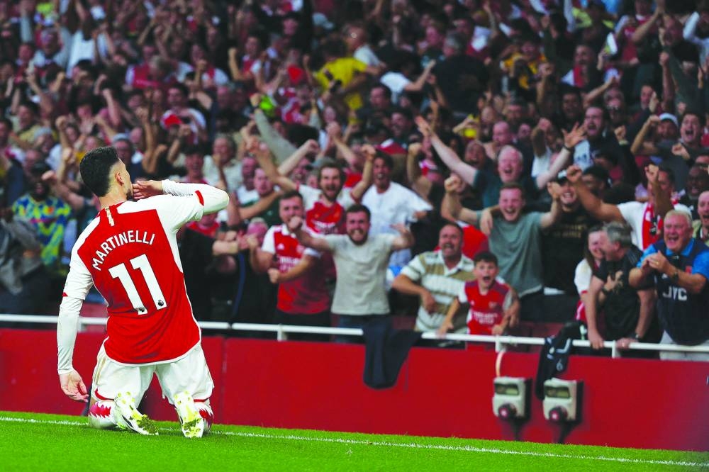 
Arsenal’s Brazilian midfielder Gabriel Martinelli celebrates after scoring the opening goal during the English Premier League match against 
Manchester City at the Emirates Stadium in London yesterday. (AFP) 