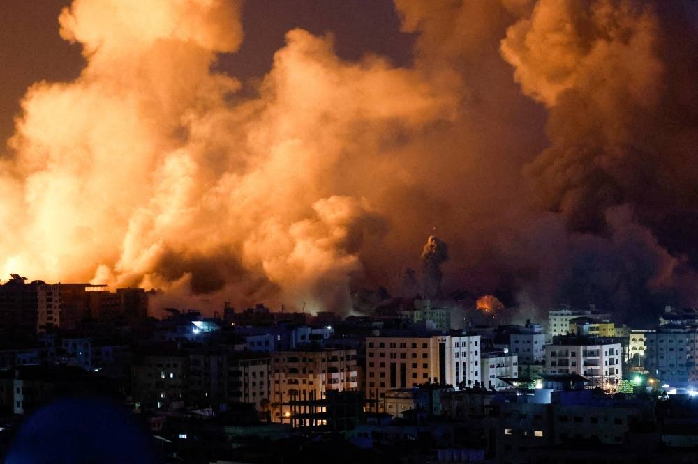 Flames and smoke billow during Israeli strikes in Gaza, Monday. REUTERS