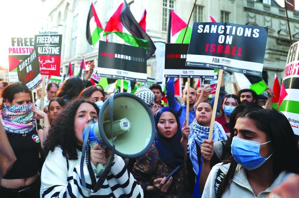 Pro-Palestinian demonstrators protest during the ongoing conflict between Israel and the Palestinian group Hamas, near the Israeli embassy in London, on Monday.