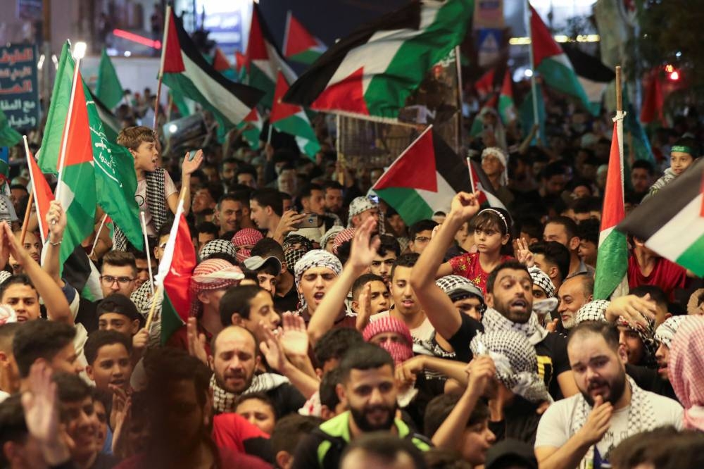 People rally to express solidarity with Palestinians in Gaza, in Amman, Jordan, Wednesday.