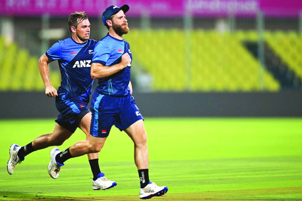 
New Zealand’s Kane Williamson (right) and Tom Latham warm up during a training session at the M.A. Chidambaram Stadium in Chennai on the eve of their World match against Bangladesh. (AFP) 