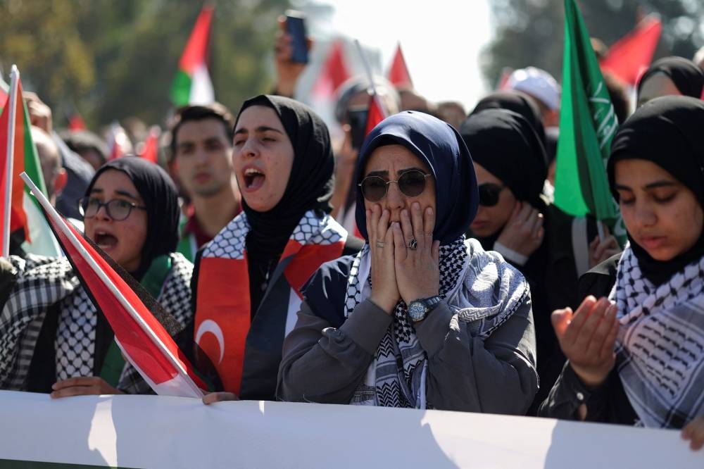 People attend a demonstration to express solidarity with Palestinians in Gaza, amid the ongoing conflict between Israel and the Palestinian Islamist group Hamas, at Beyazit Square in Istanbul, Turkey Friday. REUTERS