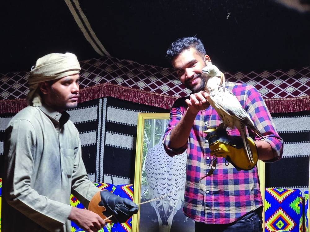 A visitor getting up close with a falcon at Expo 2023 Doha Friday. PICTURE: Joey Aguilar