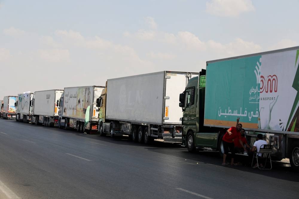 Trucks carrying humanitarian aid to Palestinians, wait on the desert road (Cairo - Ismailia) on their way to the Rafah border crossing to enter Gaza, amid the ongoing conflict between Israel and the Palestinian Islamist group Hamas, in Cairo, Egypt, Saturday. REUTERS