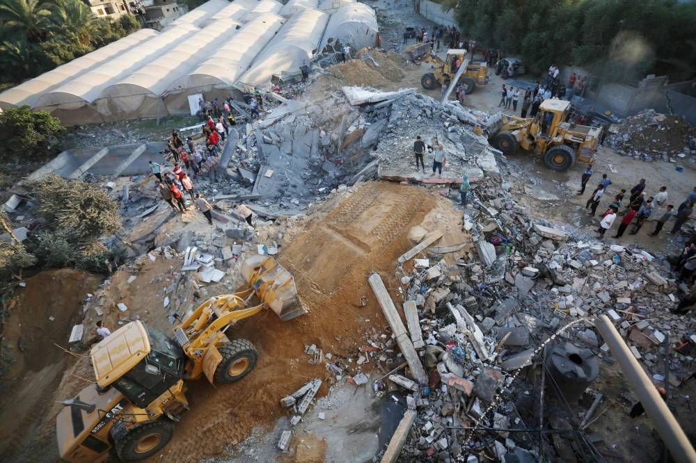 Bulldozers shift the rubble of a home destroyed following an Israeli attack on the town of Deir Al-Balah, in the central Gaza Strip, on Sunday. AFP