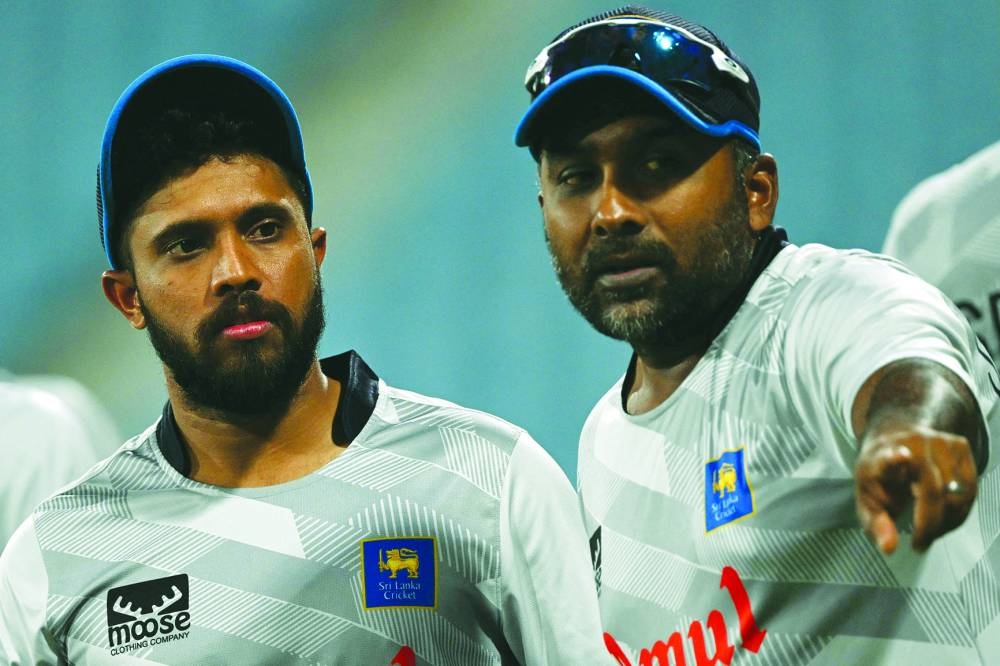 Sri Lanka's Kusal Mendis (left) listens to his team consultant Mahela Jayawardene during a practice session on the eve of their 2023 ICC Cricket World Cup match against Australia in Lucknow yesterday. (AFP) 