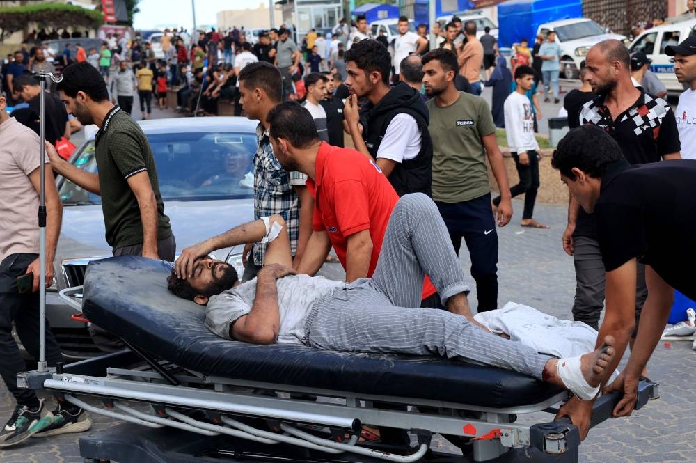A Palestinian man injured during an Israeli air strike is wheeled into the Nasser hospital in Khan Yunis on the southern Gaza Strip Tuesday, AFP