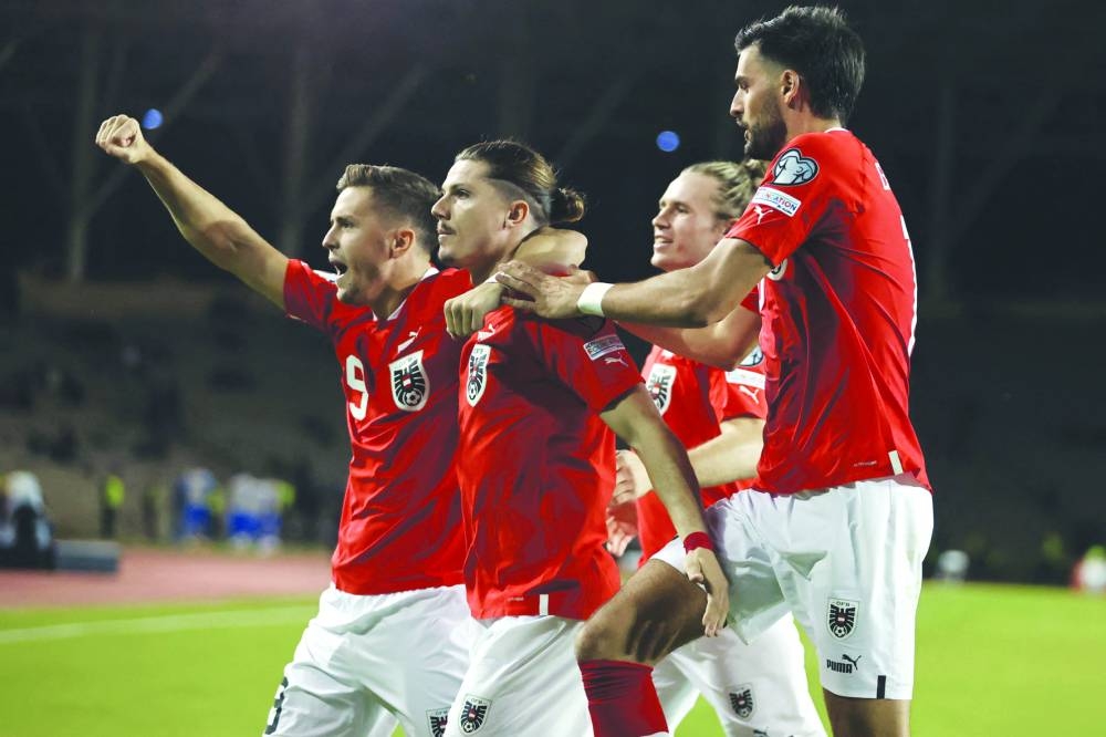 
Austria’s midfielder Marcel Sabitzer celebrates with teammates after scoring a goal from the penalty spot during the UEFA Euro 2024 Group F 
qualifying match against Azerbaijan in Baku. (AFP) 
