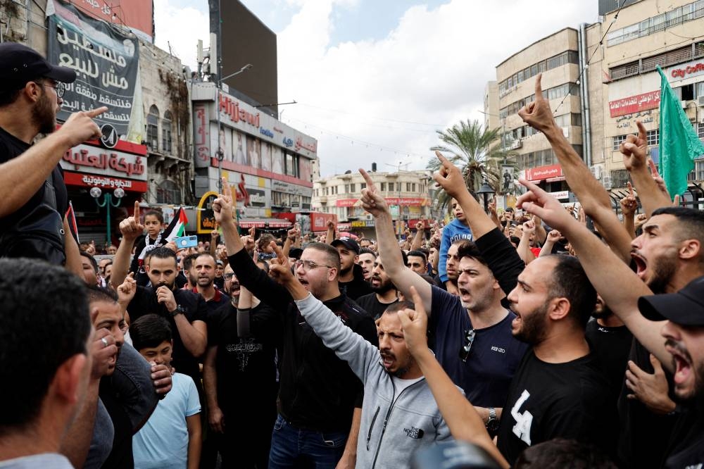Palestinians take part in a protest in support of the people in Gaza, after hundreds of Palestinians were killed in a blast at Al-Ahli hospital in Gaza that Israeli and Palestinian officials blamed on each other, in Nablus in the Israeli-occupied West Bank Wednesday. REUTERS