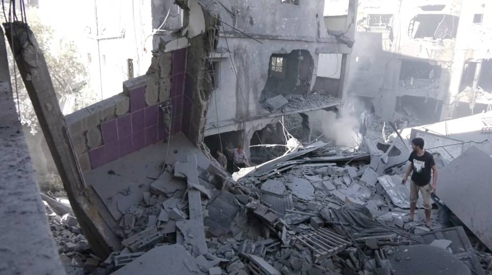 People work to remove the debris as they search for victims after a blast amid the ongoing conflict between Israel and Hamas, in Gaza City, Wednesday, as seen in this screen grab taken from a handout video.  Palestinian Media Group/Handout via REUTERS